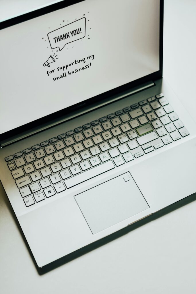 This close-up image shows a laptop displaying a thank you message for supporting small businesses.